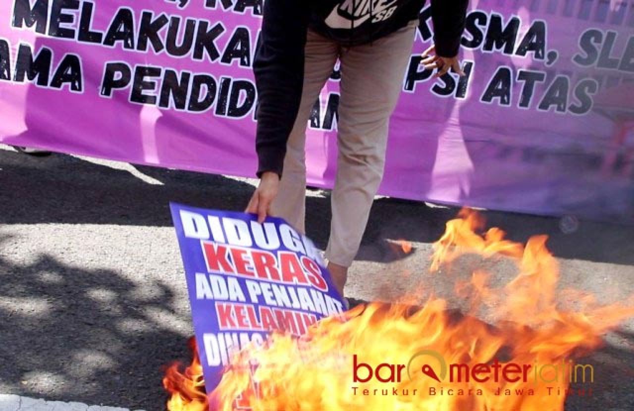 BAKAR: Massa GAM Jatim membakar salah satu poster bertuliskan penjahat kelamin. | Foto: Barometerjatim.com/BKT